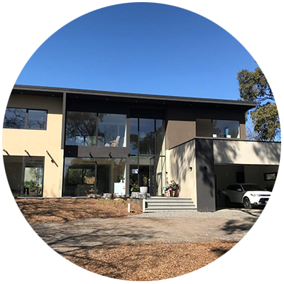 Single storey weatherboard Passive House Cottage with carport.