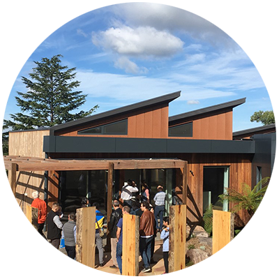 Contemporary Passive House with modern saw tooth roof, timber cladding, deck and pergola.