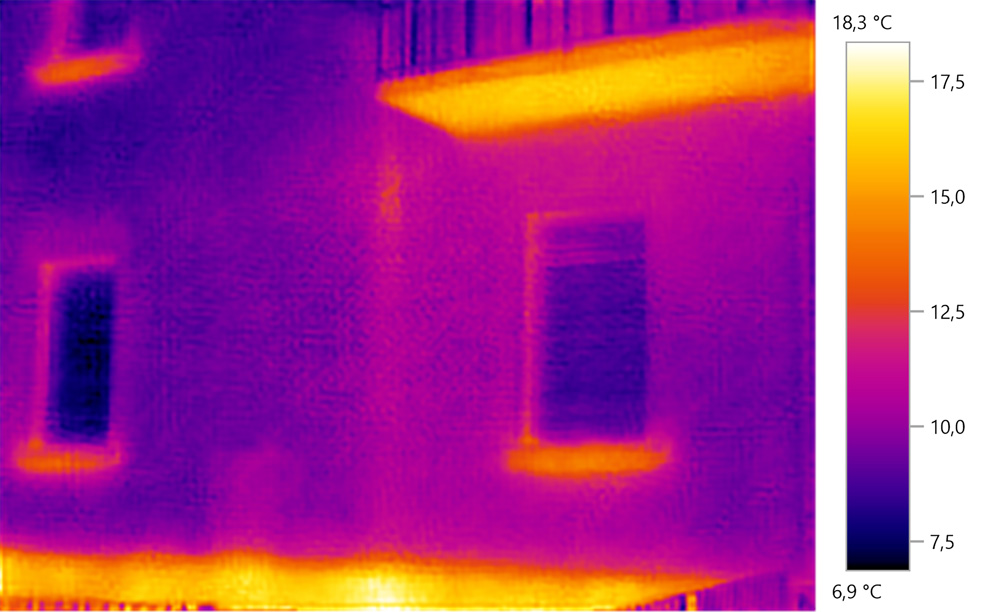 Thermal image of building exterior. Heat is conducted out of the building by a veranda and can be seen by the warmer colour.